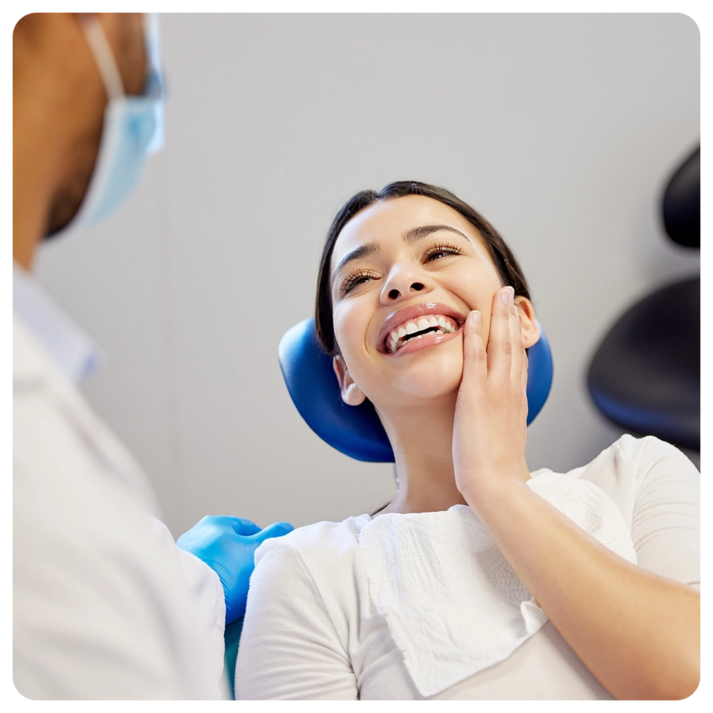 Female patient, satisfied and smile on consultation for canal procedure and oral care