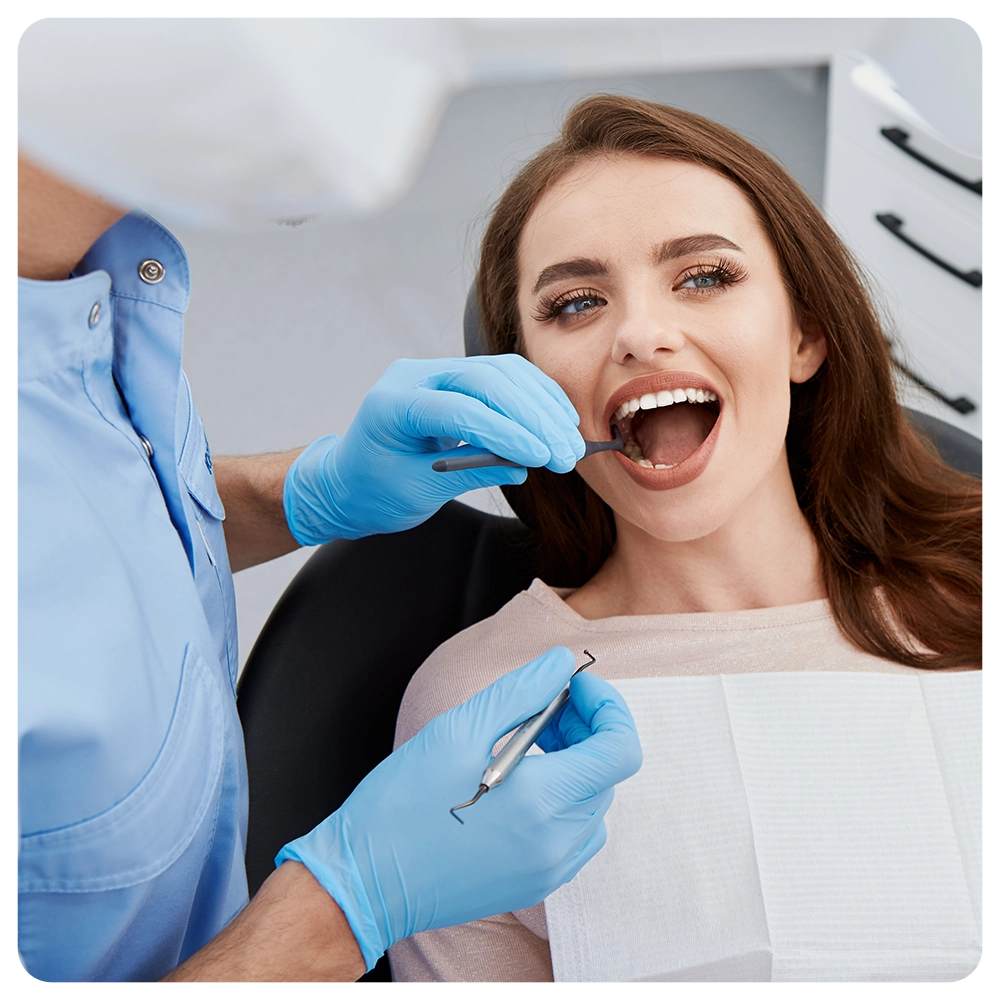Dentist working with patient at light medical background, modern clinic, dental clinic, healthy teeth, satisfied client, portrait