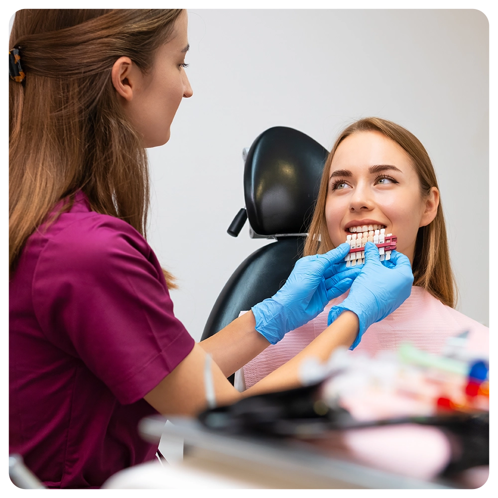 The dentist chooses the ideal shades of white to enhance the patients smile