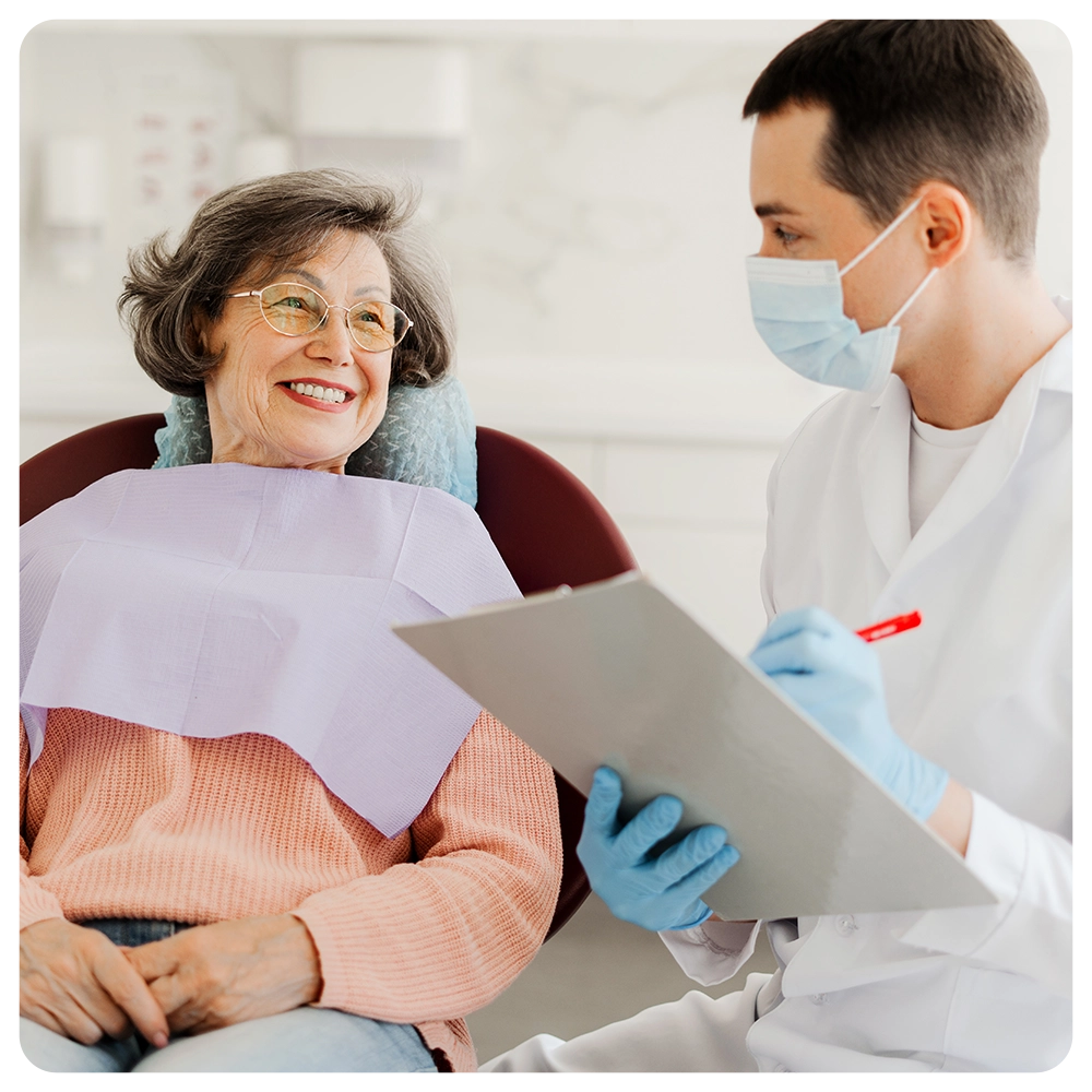 Senior, attractive woman, patient visiting professional doctor, talking, dentist writing down complaints, working in modern dentistry