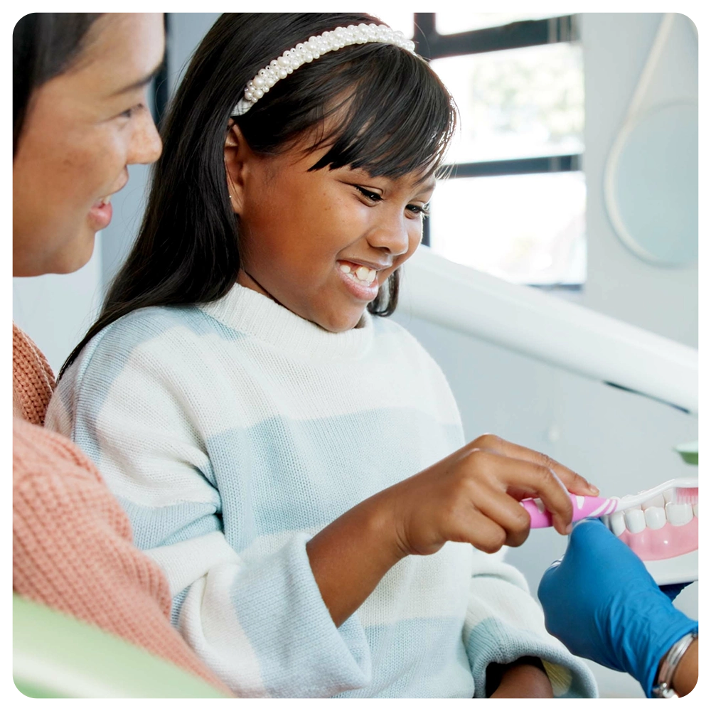 Girl, dentist or education on brushing teeth with toothbrush in practice or child friendly dentistry of tooth hygiene