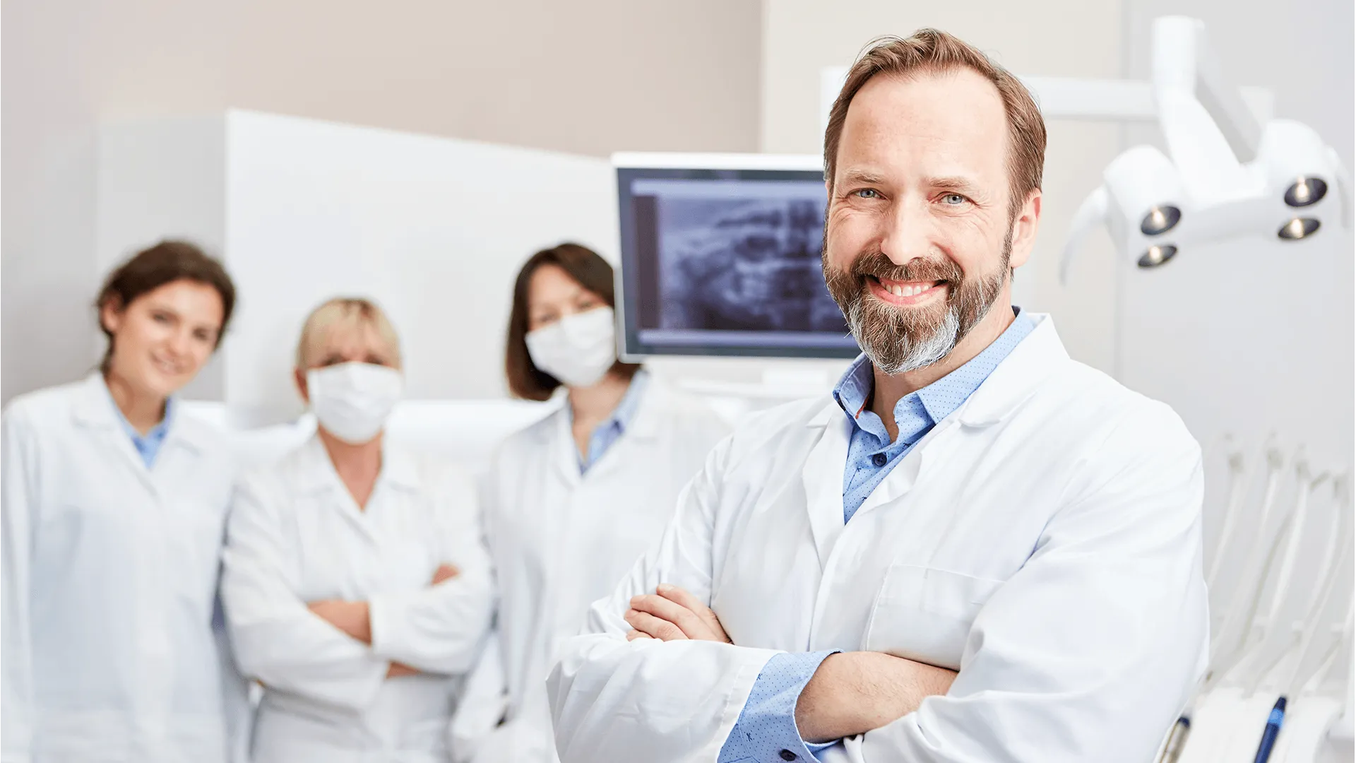 Smiling dentist with team to training in the dental clinic