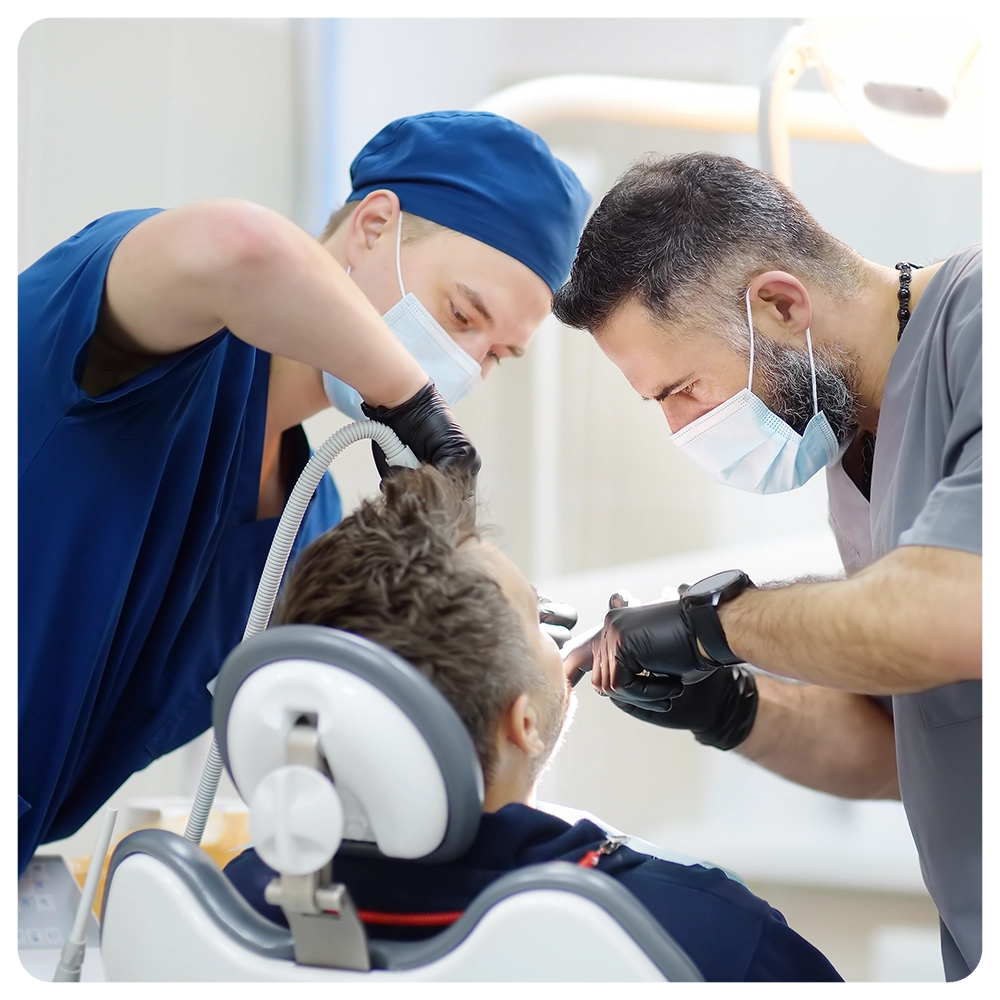 Surgeon and nurse during a dental operation.
