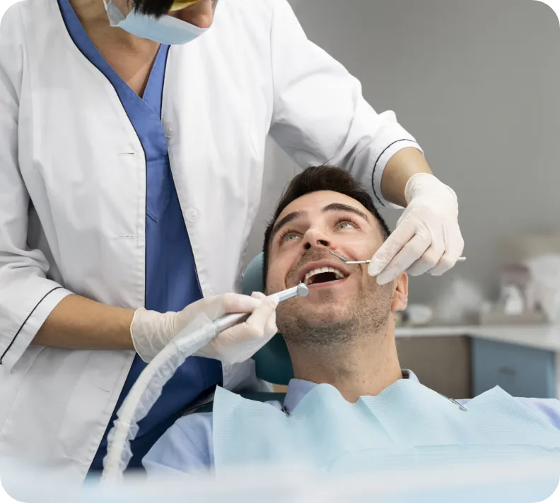 Man receiving a dental cleaning.