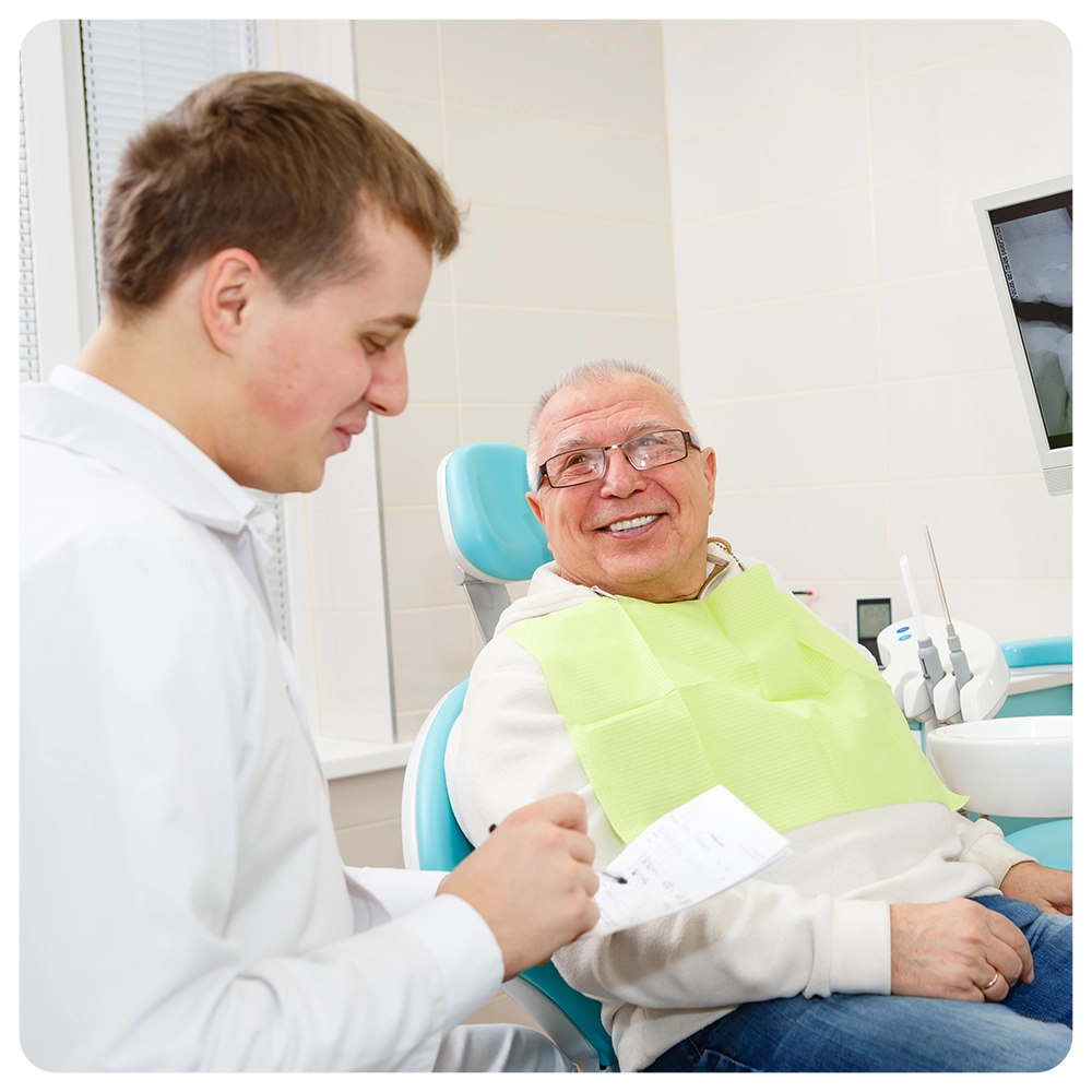 Happy and smile senior man 70-75 years old with white teeth on review of a dentist, sitting in chair dental clinic. 