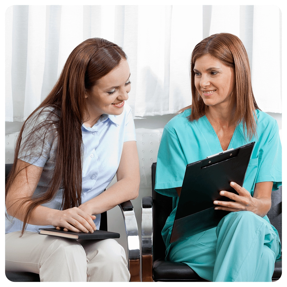Nurse and patient reviewing medical chart in a waiting room.