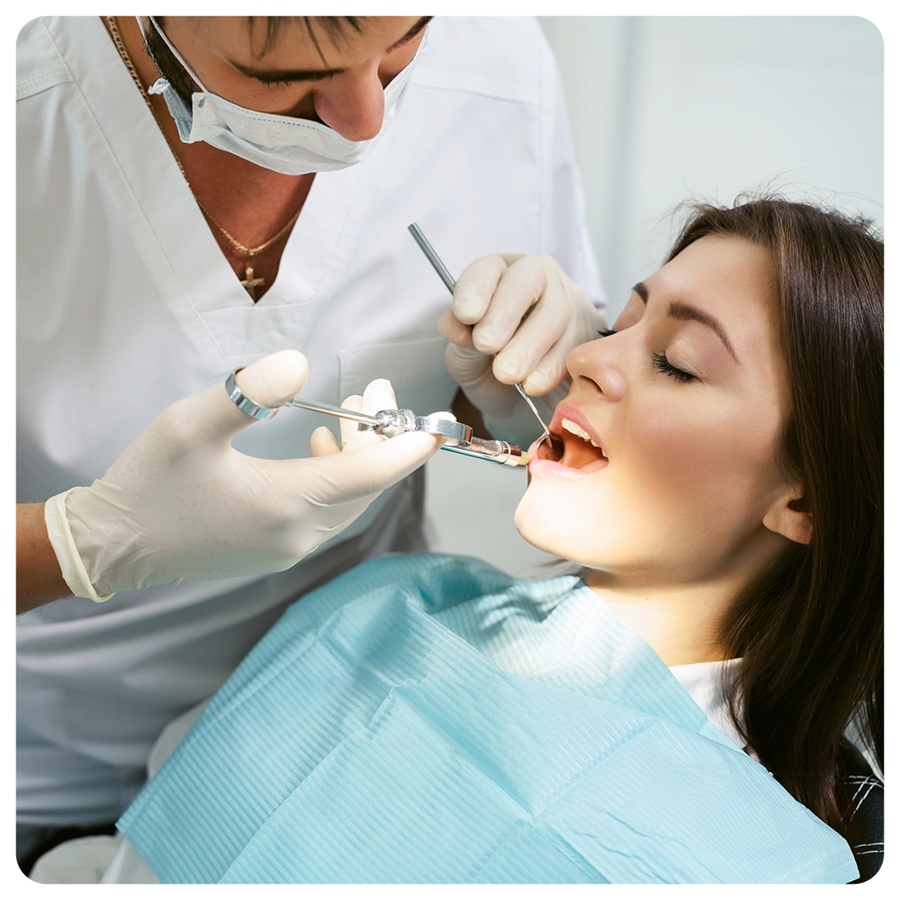 Painkiller anesthesia injection. Dentist examining a patient's teeth in modern dentistry office